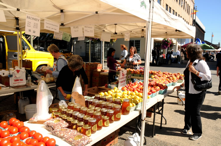 The weekly Farmers Market draws shoppers to downtown